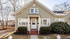 A single-story house with a front porch, a small entryway, and a mailbox.