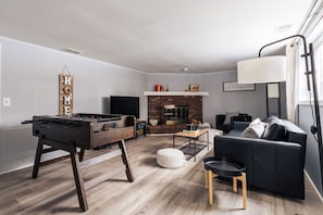 Smart TV, fireplace, foosball, books
