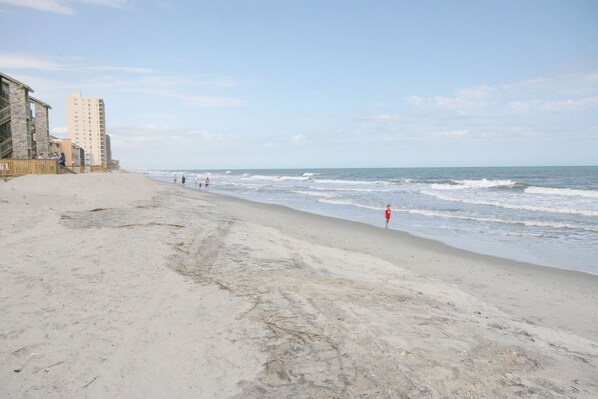 Guests can enjoy ocean views from the hotel's balconies overlooking the sandy shoreline.