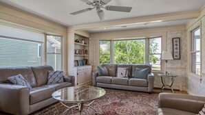 A spacious living room with two leather sofas, a glass coffee table, and a patterned rug. - Spacious Beach Villa - Ocean Views - 3 Minute Walk to Shore - Available All Year (Wells)