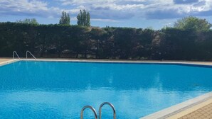 A rectangular swimming pool with clear blue water, surrounded by a tiled deck. - Cozy Studio with Pool Access, Port View, Parking Included - Agde (Cap d'Agde naturisme)