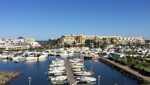 A marina with numerous boats docked, surrounded by buildings and a clear blue sky. - Cozy Air-Conditioned Apartment with Pool Access, Terrace & Private Parking in Agde (Cap d'Agde naturisme)