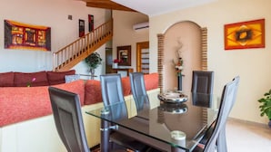 A dining area with a glass table, chairs, and a central decorative piece. - PRIVATE VILLA WITH POOL VALLADA.No for rent to under 25 years old for S.Joan (ciutadella de menorca)