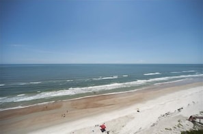 A beach with a clear sky and calm sea.