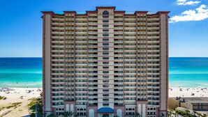 A high-rise hotel with multiple balconies, a beach view, and a pool area. - Freshly updated, fully loaded, w/amazing gulf views from the LR & Master bdrm. Beach service included! (Panama City Beach)