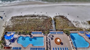 A resort with multiple swimming pools, a beach area, and a lifeguard tower. - Freshly updated, fully loaded, w/amazing gulf views from the LR & Master bdrm. Beach service included! (Panama City Beach)