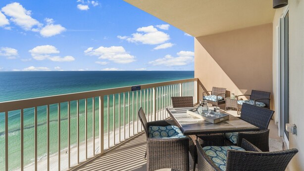 A balcony with wicker furniture and a view of the ocean. - Freshly updated, fully loaded, w/amazing gulf views from the LR & Master bdrm. Beach service included! (Panama City Beach)
