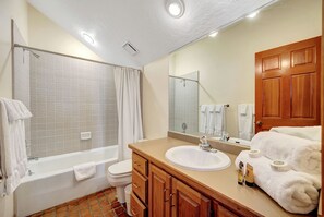 A bathroom with a bathtub, toilet, sink, and wooden vanity. - Ski in/Ski Out to Snowbird in this Beautiful Unit with Hot Tub and Fireplace (Alta)