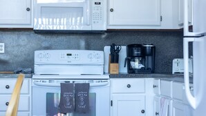 A kitchen with white cabinets, a white stove, a microwave, a coffee maker, and a toaster. - Dog Lover's Chalet w/ Fenced Yard, AMAZING VIEW 10mi to Camelback/Hiking/Casino (Sciota)