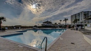 A swimming pool with a lifeguard tower and palm trees in the background. - Romantic Getaway II w/ WiFi in Oceanfront Gated Resort - 1 Bedroom Lodge (Myrtle Beach)