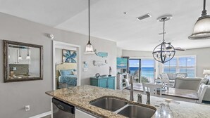 A kitchen with granite countertops, stainless steel appliances, and a view to the living area. - Maravilla 2403   2Bed/2Bath Gulf front, Pet Friendly, Beach Service (Miramar Beach)