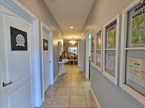 Stylish hallway with framed artwork and informative bulletin boards.