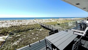 A beachside view from an elevated deck with a clear view of the ocean and sandy dunes. - Endless Summer-Gulf Front custom home for 20+.  Pup friendly! (Navarre)