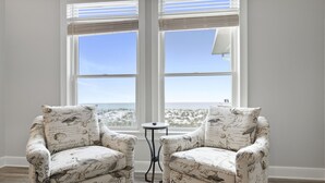 Two upholstered chairs with a bird print, positioned in front of a window with a view of the beach. - Endless Summer-Gulf Front custom home for 20+.  Pup friendly! (Navarre)