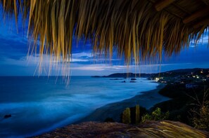 Enjoy breathtaking ocean views from a secluded thatched roof retreat.