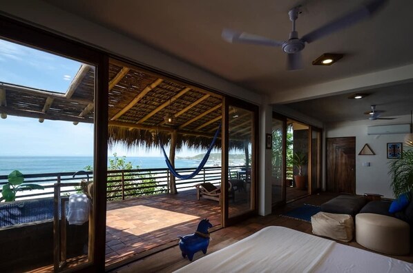 Enjoy ocean views from the large window in this room, which features a comfortable bed and a cozy seating area.