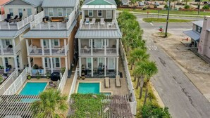 A multi-story residential building with a pool, balconies, and a street view. - 🌈Amzng Gulf view, 4 Bd/3.5 Bath Home,🏖Pvt Heated Pool☀️,🌴Just Steps to Gulf🌴 (Panama City Beach)