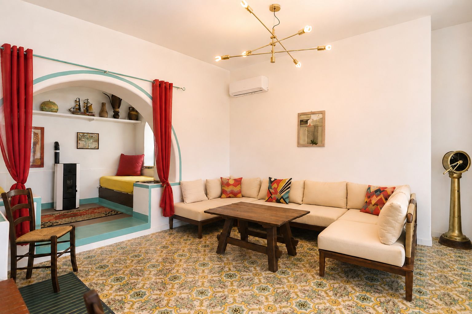 A living room with a sofa, a wooden coffee table, a patterned floor, and a ceiling light fixture.