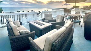 A balcony with wicker furniture, a table, and an umbrella, overlooking a body of water. - San Clemente's "Jewel" - Blue Whale Inn #D (San Clemente)