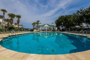 A clear blue pool surrounded by lounge chairs and palm trees, with a gazebo in the background. - Luxury Home in Gated Community; 3 Minute Walk to Beach; Access to Oceanside Community Pool & Cabana (Isle of Palms)