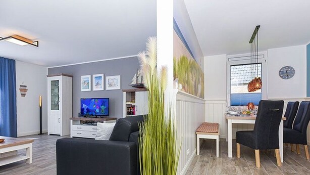 A modern living room with a sofa, TV, dining area with chairs, and a large window. - Ferienwohnung Schlipf in Carolinensiel - Ferienwohnung Schlipf (Wittmund)