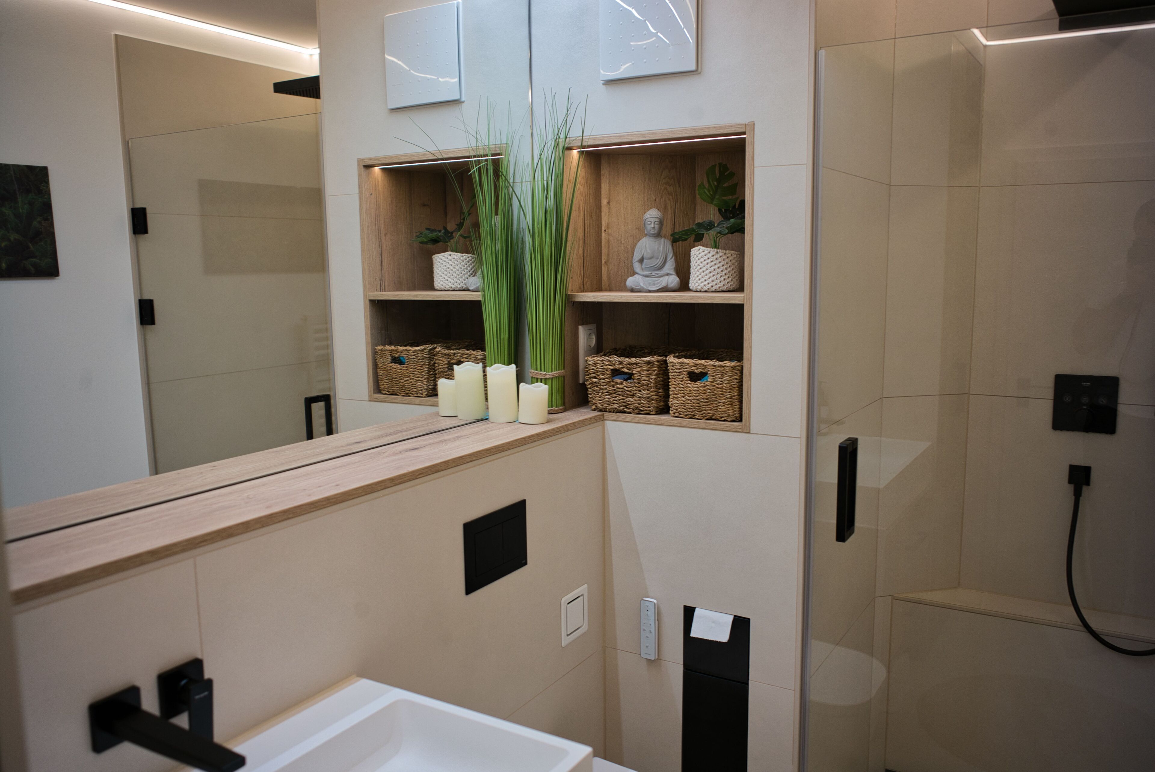 A modern bathroom with a wooden vanity, a mirror, a toilet, and a shower area.