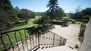 A staircase leading to a garden with a view of a park.