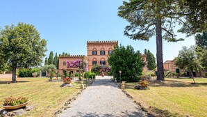 A building with a central courtyard, surrounded by trees and potted plants.