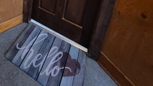 A wooden door with a doorknob and a small electronic lock. - Cute & cozy 1 bedroom apartment - sleeps 4 (Negaunee)