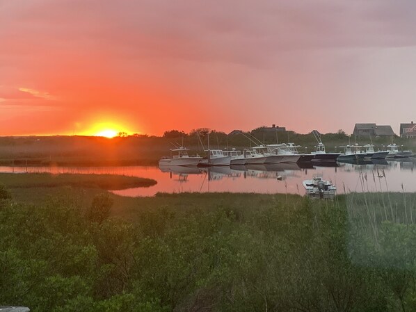 A marina with boats docked at sunset.