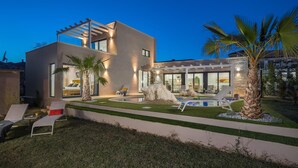 A modern house with a swimming pool, outdoor seating, and a well-maintained garden. - Gorgeous home in Kastelir (Kastelir)