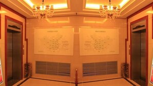 A mirrored hallway with two elevators, chandeliers, and ventilation grilles. - Greentree Inn Lanzhou Yantan Road Express Hotel (Lanzhou)