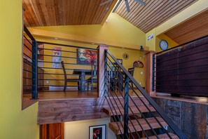 Staircase connects living areas in this warm and inviting space.