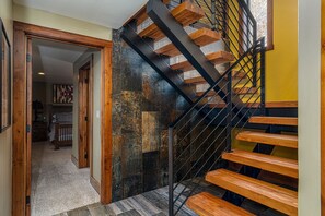 Stairs lead to an upper level, flanked by walls with a mix of textures.