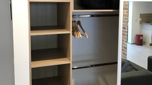A modern closet with multiple shelves and a hanging rod. - Studio Atypique (Fréjus)