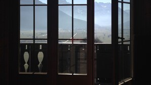 A room with a large window offering a view of a mountainous landscape. - Exclusive Chalet with amazing view (Benken)