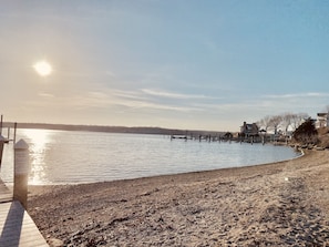 Enjoy waterfront views from the comfort of your home, with a dock and access to the pebbly shore.