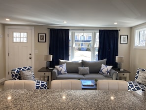 Relax in this stylish living room with a comfortable sofa, coffee table, and side tables.