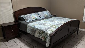 A bedroom with a bed, a nightstand, and a dresser. - Snowbirds escape / vacation gateway (Englewood)