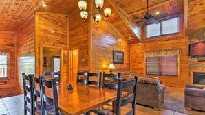 A wooden cabin interior with a dining area, a fireplace, and a living room. - Stunning Views - Great Location (Gatlinburg)