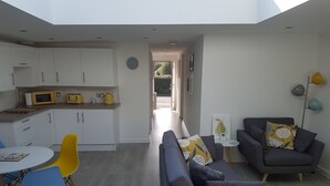 A modern interior with a kitchen, dining area, and living room. - The Coneygree @ Northwick (Worcester)