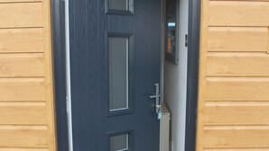 A wooden door with a dark panel and a welcome mat at the entrance. - The Coneygree @ Northwick (Worcester)