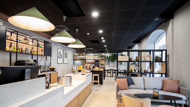 A modern interior with a bar area, seating, and kitchen.