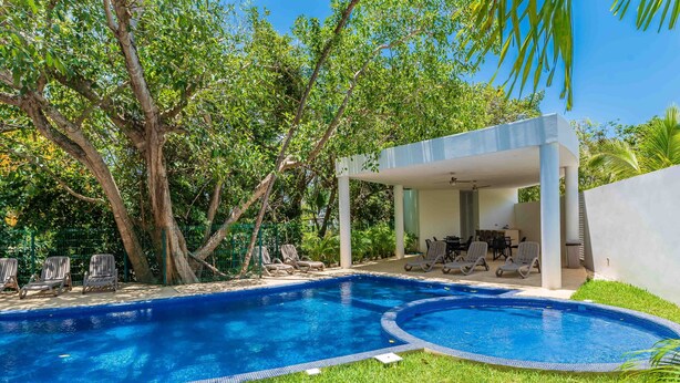 A swimming pool with a covered seating area and lounge chairs. - Retreat into Exotic Paradise in Riviera Maya, 15 minute walk to beach (residencial El Cielo, Solaridad)