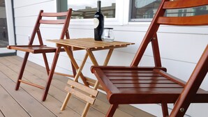 A wooden deck with a table and two chairs. - Brand new 2021 3 bedroom 2 bath condo. Great location just off interstate 90. (Livingston)