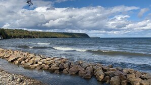 Une côte rocheuse où les vagues s’écrasent contre les rochers.