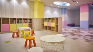 A children's play area with colorful furniture and bookshelves. - Oursea Hotel (Taichung)