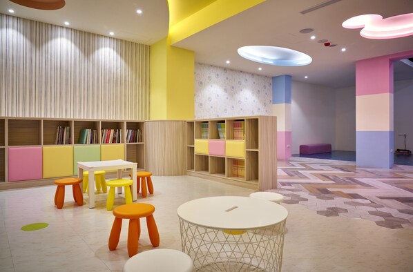 A children's play area with colorful furniture and bookshelves.