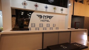 A reception desk with a logo for 'HYPE MOTORSPORTS HOTEL'. - Swiss-belexpress Nilai (Nilai)