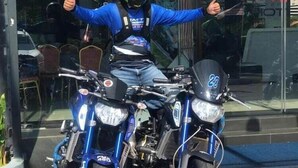 A person on a blue motorcycle with the number 28, giving a thumbs up. - Swiss-belexpress Nilai (Nilai)